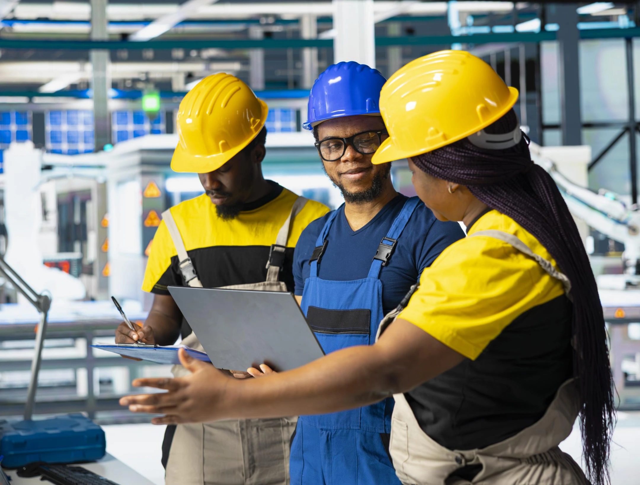 Electrimecha technicians reviewing industrial engineering plans in Tanzania